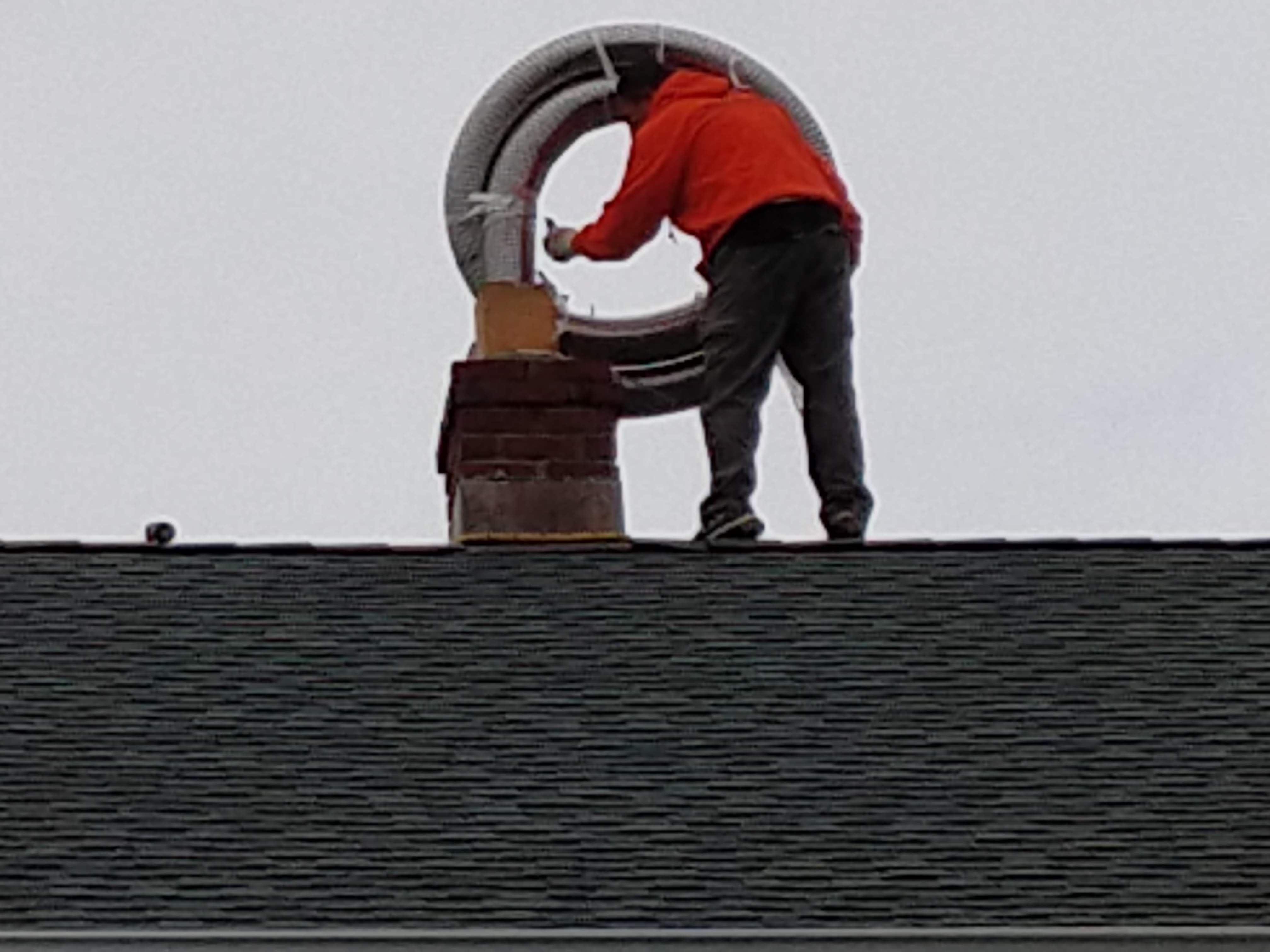 Flexible stainless chimney liner being installed in Plainview, New York
